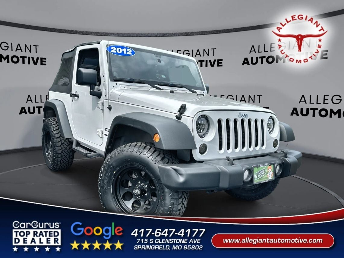 2012 Jeep Wrangler Sport SUV 2D in White — front three-quarter view
